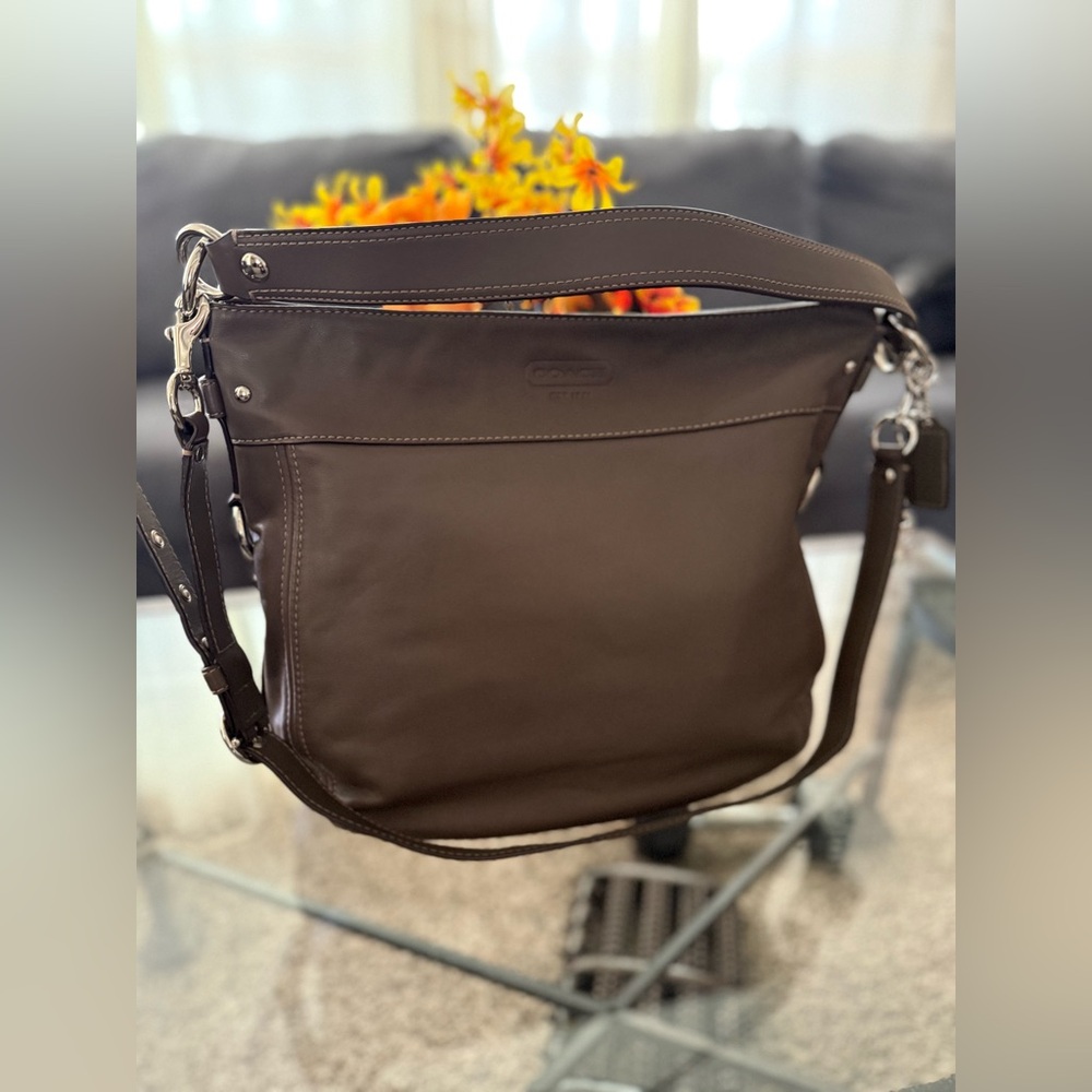 The Coach F14706 is a vintage-style large "Zoe" hobo shoulder bag